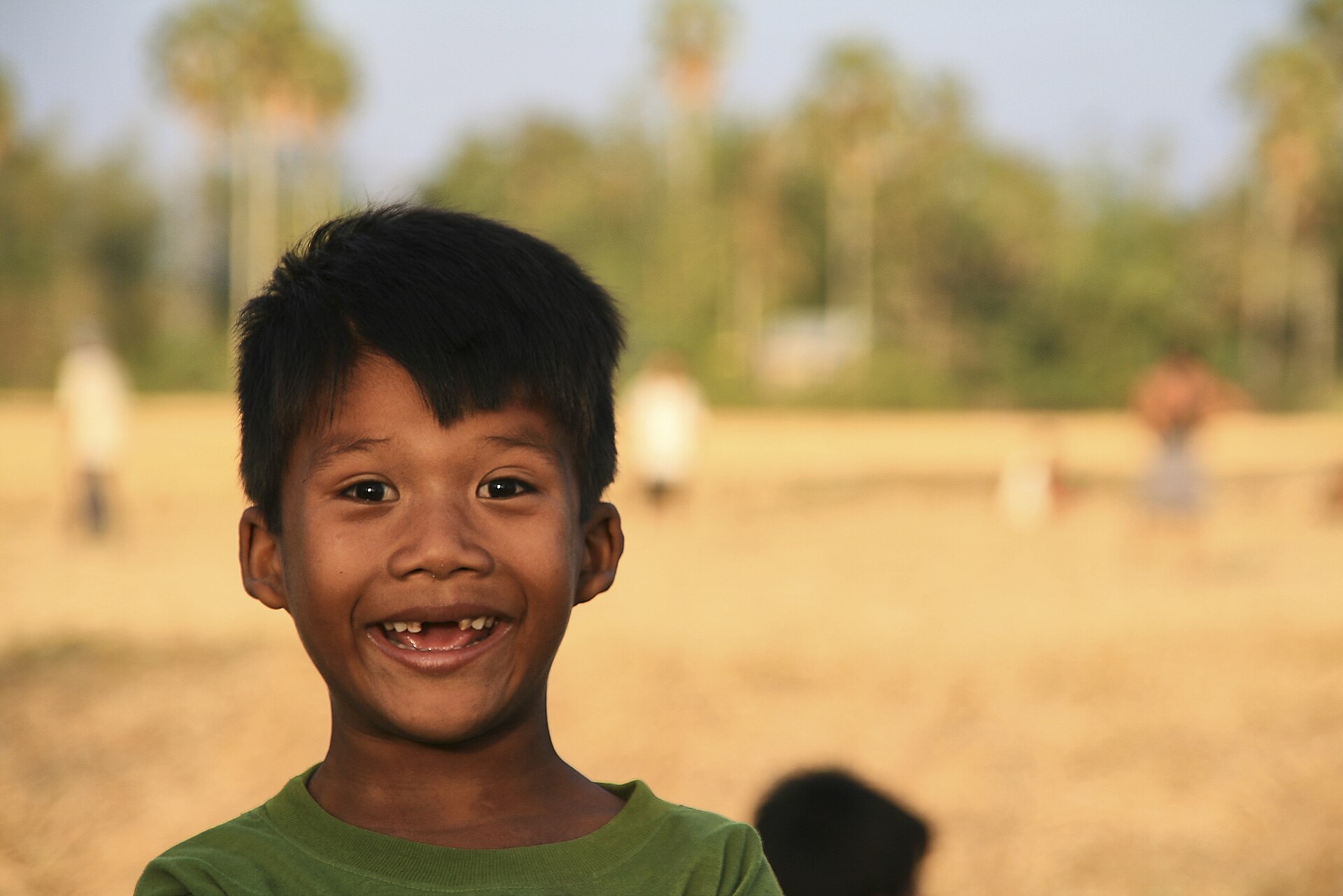A child's laugh showing baby teeth