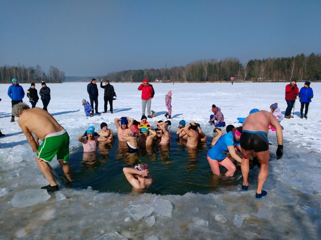Winter swimmers entering icy water