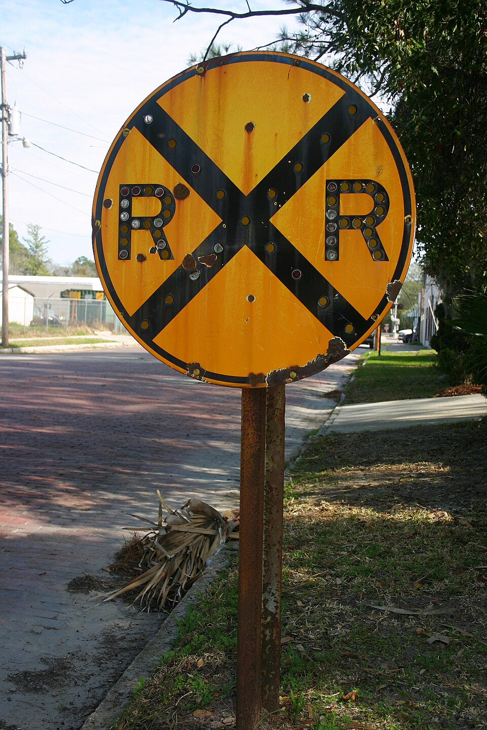 Round yellow railroad advance warning sign (W10-1) with black X and R X R letters