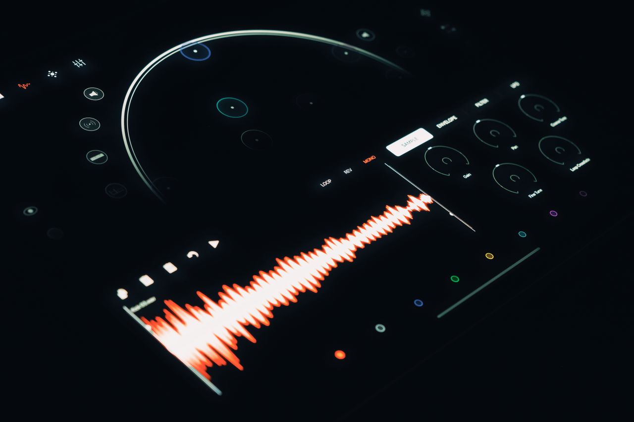 Glowing orange sound wave on a digital audio interface